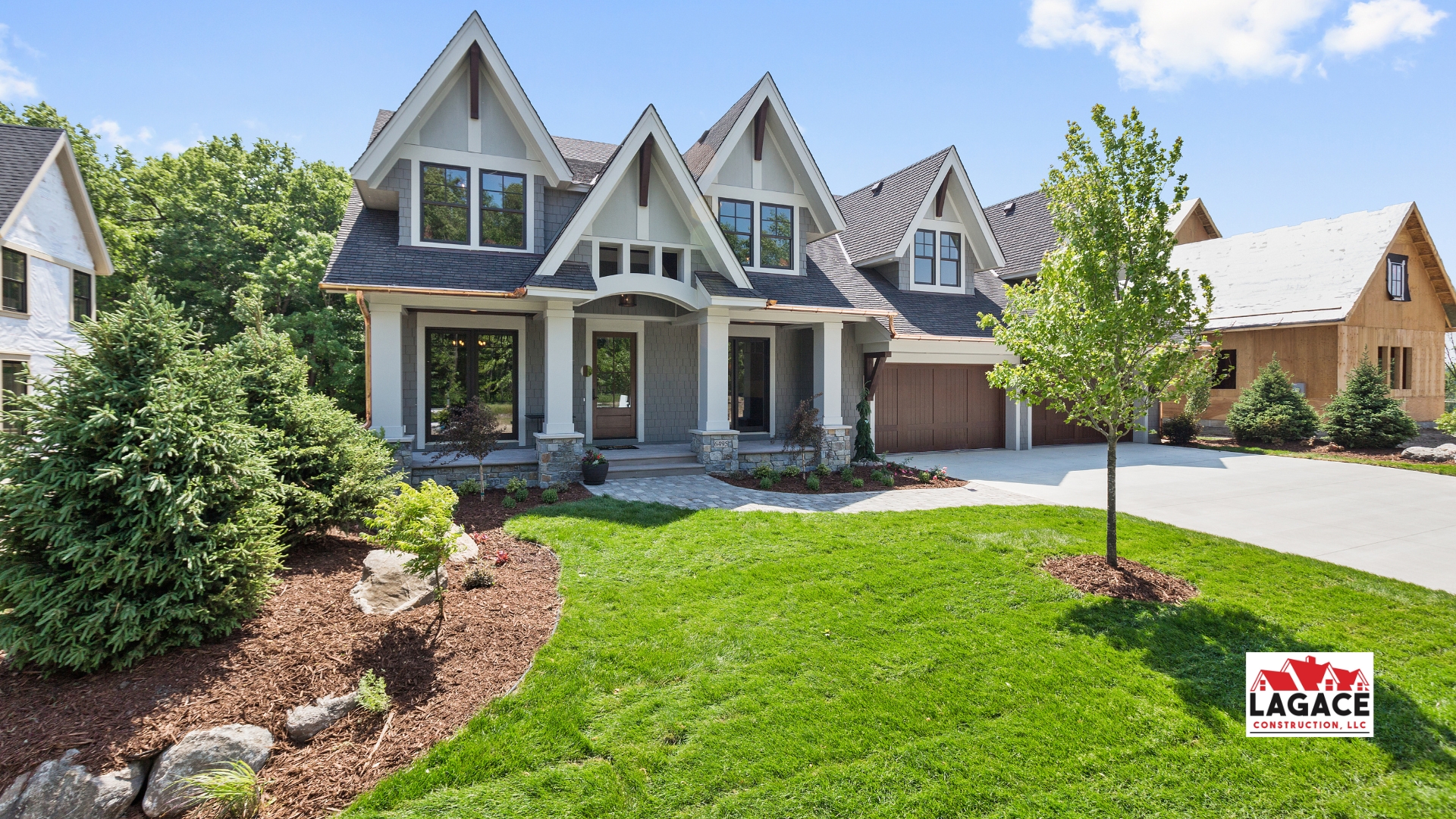 Craftsman-style home in Hebron, CT with gabled rooflines, stone accents, and a spacious front porch, built by Lagace Construction.