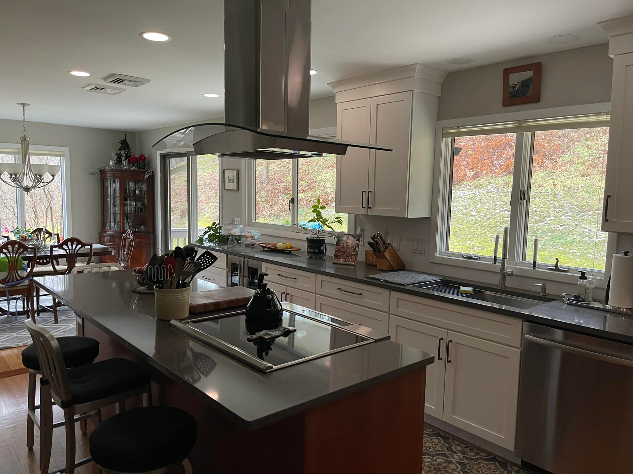 Open concept kitchen renovation in Connecticut with custom island, modern lighting, and dining area by Lagace Construction.